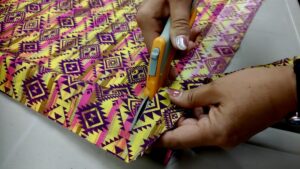 Bright fabric and sharp scissors—tools of the trade at this week's ribbon dress making session in Borups Corners.