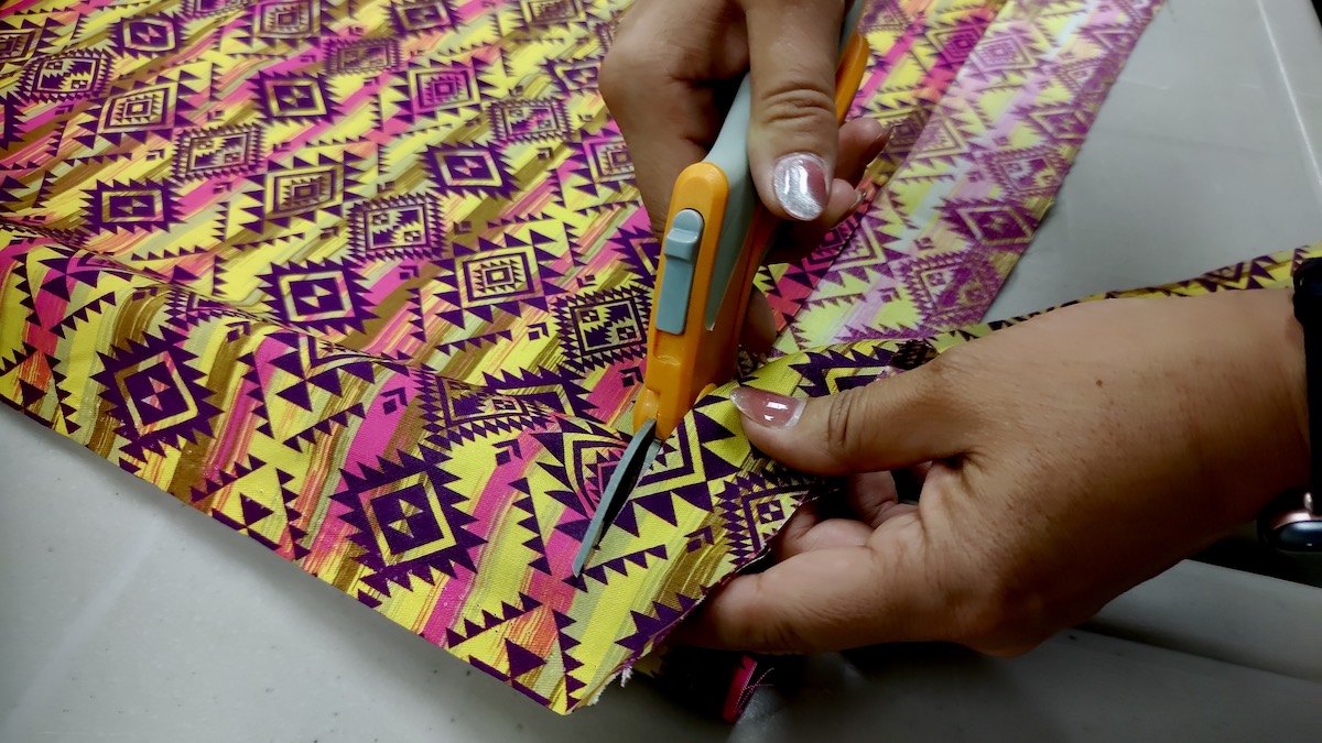 Bright fabric and sharp scissors—tools of the trade at this week's ribbon dress making session in Borups Corners.