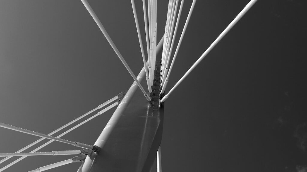 Provencher Bridge floats between breath and concrete, a tethered gesture over water’s slow murmur. Light fractures across its spine like memory refracted—half civic promise, half spectral hush. It does not span space, but thought—an architecture of pause, where crossings blur into echoes and the river forgets which way is forward.