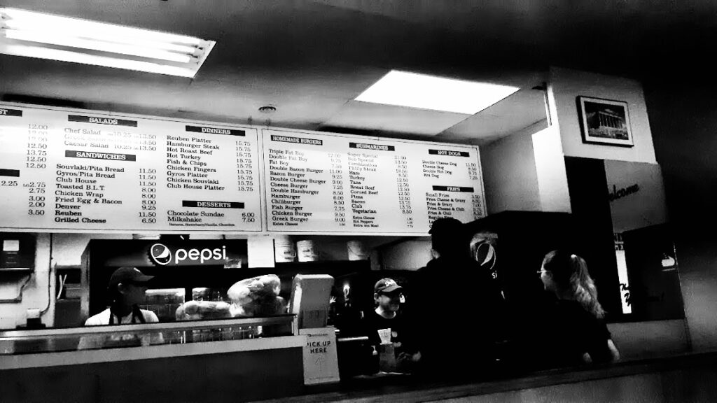 You don’t enter these diners—you return to them. Even if it’s your first time. Fluorescent light softens. Coffee refills itself. The staff doesn’t change, only shifts. These places are stitched together with decades. Outside, everything’s different. Inside, nothing ever really left.