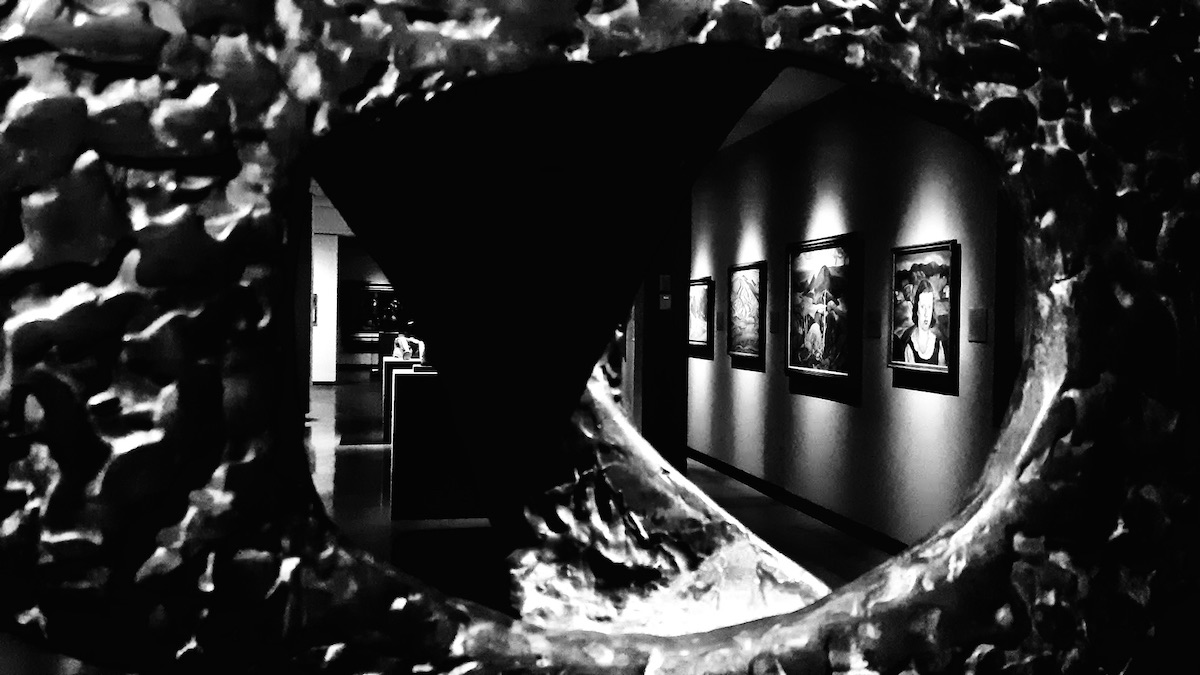 A hollow in stone opens the eye. Shadows wait patiently, folding silence into silence. Paint bleeds across decades, whispering in light. You are the lens. Time coils around the absence. Meaning slips between surfaces—seen, not seen. There is no centre, only edges pretending to hold form.