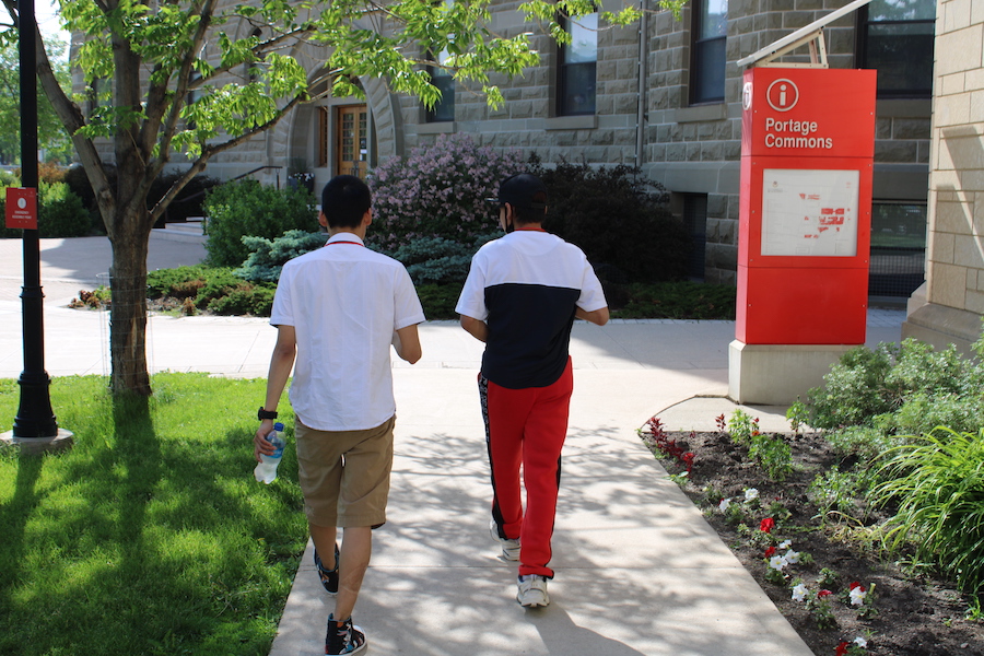 Photo: Ethan Tassiuk, and Tony Eetak head to campus at the University of Winnipeg. The pair were co-facilitating a roundtable discussion on the use of arts in support of inclusive and participatory learning environments at the University of Winnipeg June 21, 2022.
