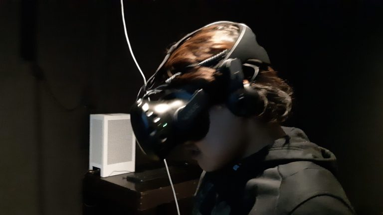 Emerging youth artist and musician Tony Eetak explores a VR installation in summer 2024 at the Urban Shaman Contemporary Art Gallery in Winnipeg, Manitoba.