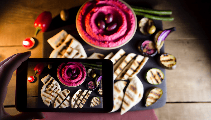 Vibrant and textured, this raspberry-infused roasted eggplant hummus platter is framed by the warm curves of pita and fresh vegetables. With the soft glow of candlelight and delicate shadows, this image captures the essence of rustic elegance in every bite. It’s one of the many exciting creative explorations we've been undertaking in our AI food arts activities since last year.