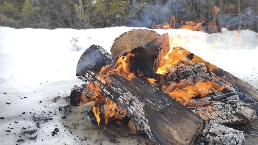 Nurturing a fire, like nurturing relationships, requires care and attention. Just as we tend the flames, Inuuqatigiitsiarniq teaches us to tend to the connections that warm our community and fuel our creative spirit. Photo: Tony Eetak