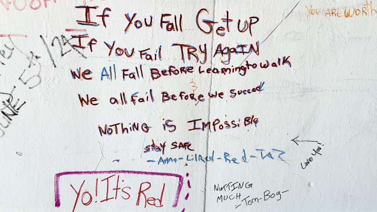 "If you fall, get up." We found this under the railway bridge near Higgins and Main.