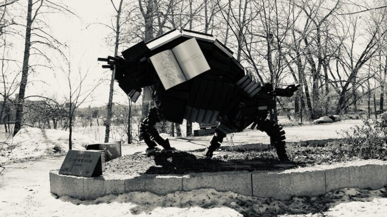 Among bare branches and snow-laced silence, the book-buffalo waits—pages frozen in time, wisdom stacked into muscle and memory. It is not sculpture, but spellwork. It holds what we forgot we carried: story, survival, and the soft hoofbeats of future paths.