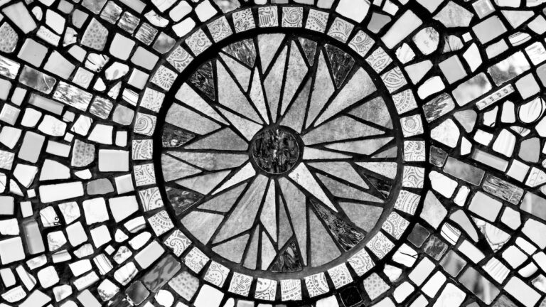Each fracture finds its place. Each piece, once discarded, now holds position in something greater. This mosaic doesn’t erase what’s broken—it listens to it, arranges it, builds a compass out of the scattered. To stand at its center is to feel the world pulling gently toward wholeness.