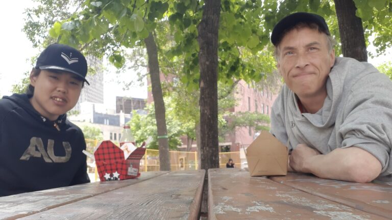 Jamie Bell and Tony Eetak catch up over poutine at Red River College’s Exchange District Campus in Winnipeg. The two artists are in the city this summer for Niriqatiginnga, a pilot project focused on arts entrepreneurship and food security, supported by Manitoba Agriculture and the Sustainable Canadian Agricultural Partnership.