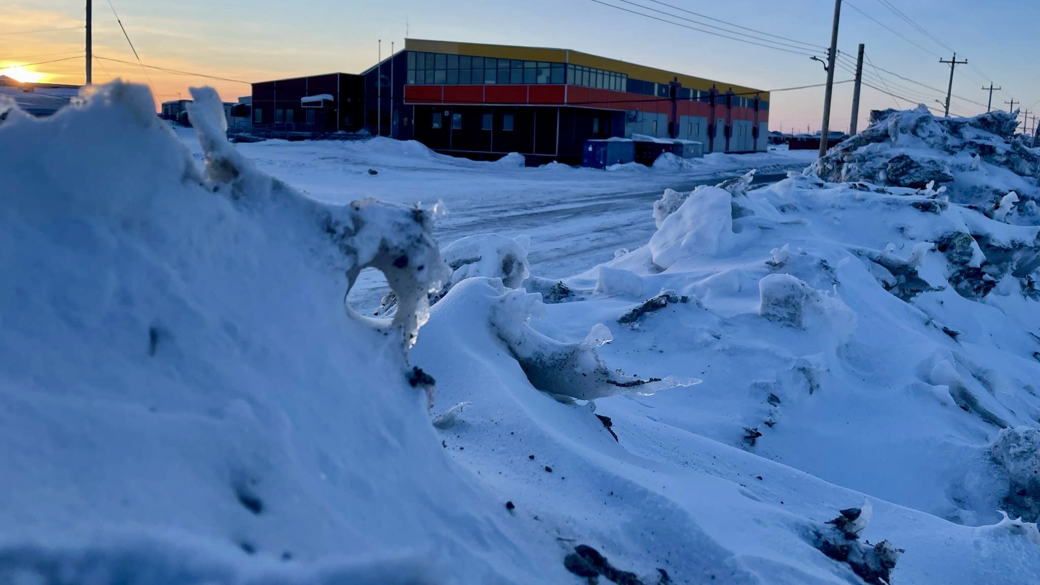 Even in the heart of our community, winter's presence is felt. The school stands as a center of learning, surrounded by the enduring snow.