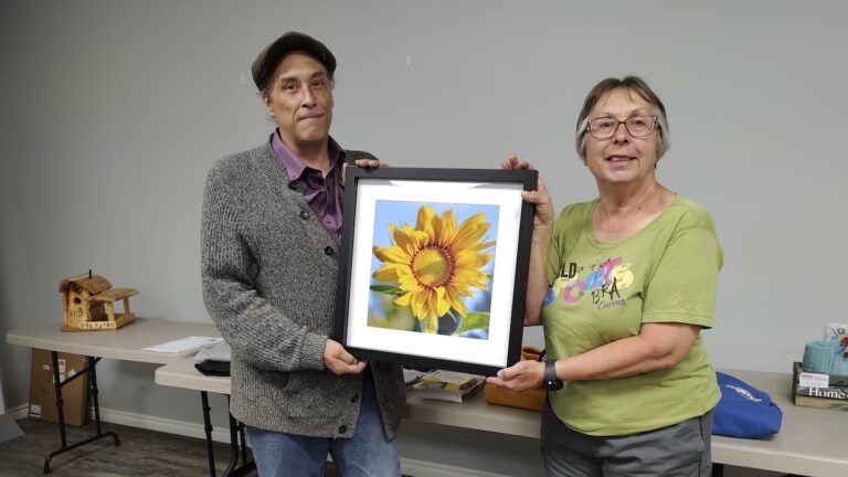 Jamie Bell from The Arts Incubator presents a signed print to Michelle Robinson from the Local Services Board of Melgund for their upcoming Silent Auction to be held during Canada Day activities.