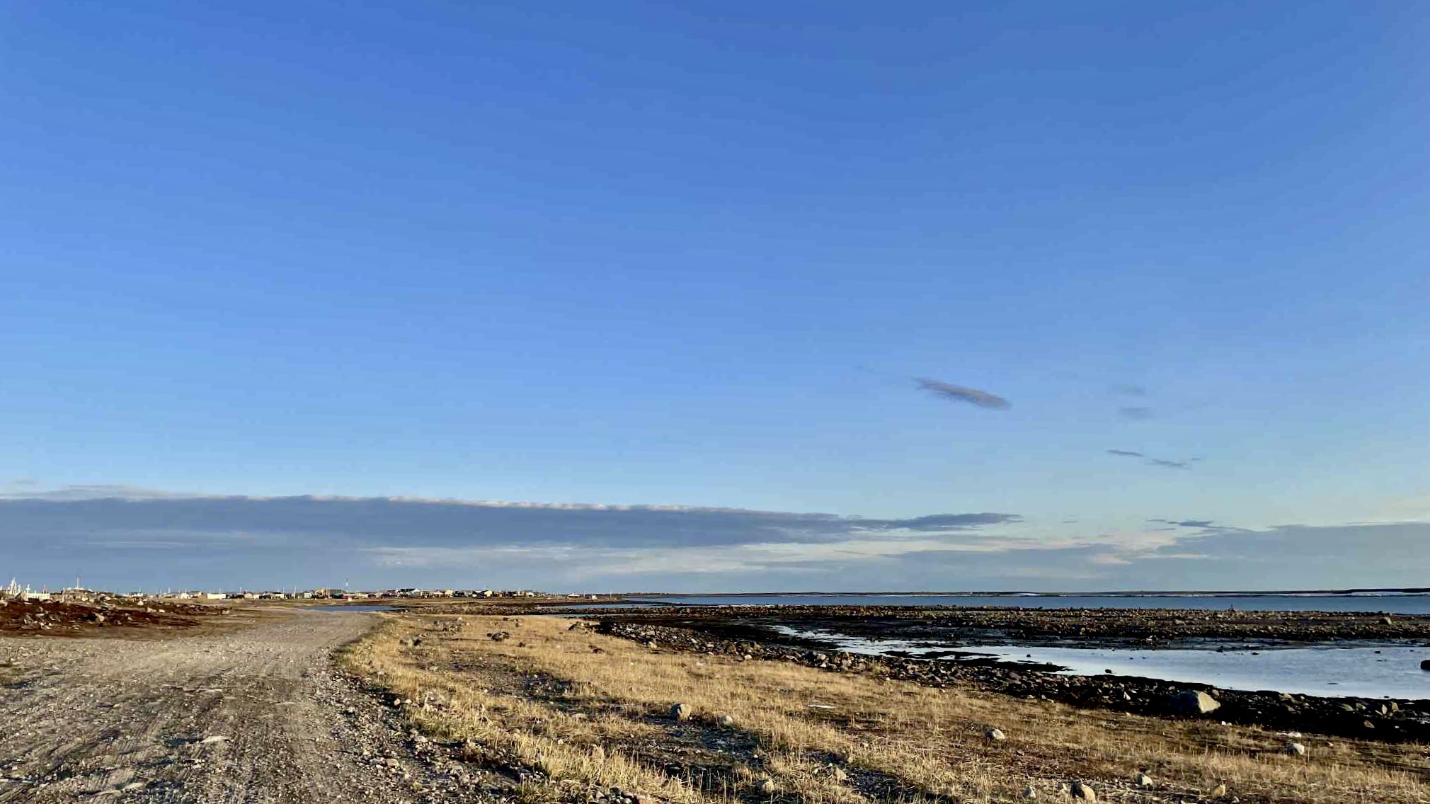 This unpaved shoreline road leads past the edge of town, where land, sky, and water meet in a quiet rhythm. It's a place to slow down and reconnect—far from the urban pace of Winnipeg.