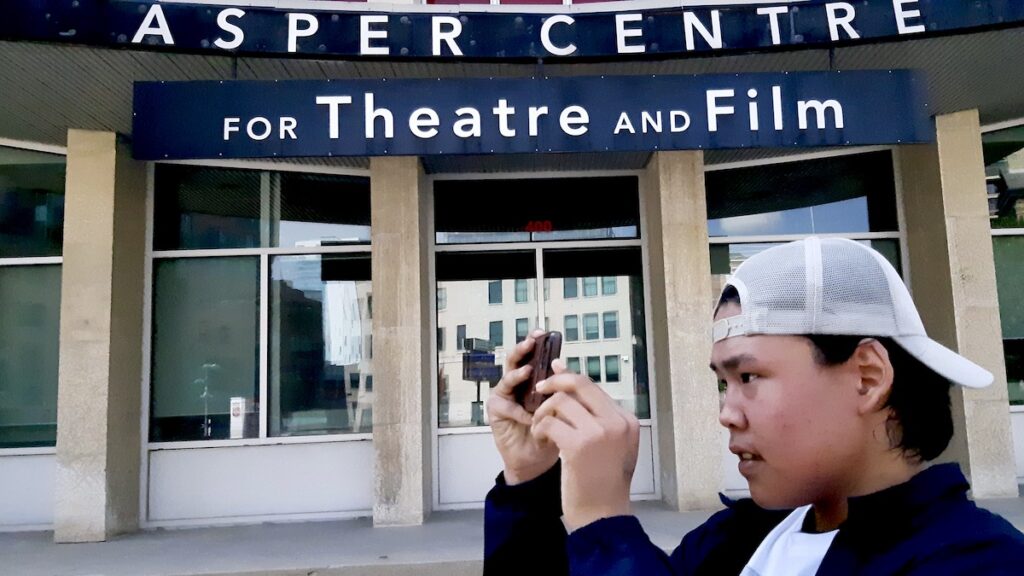 Tony Eetak, a founding member of our program, frames a shot outside the Asper Centre for Theatre and Film in Winnipeg. Photo: Jamie Bell
