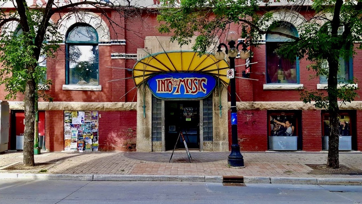 A view of Into the Music in Winnipeg’s Exchange District, a cozy record shop filled with shelves of vinyl, CDs, and music memorabilia. The store’s warm atmosphere invites music lovers to browse and discover hidden gems.