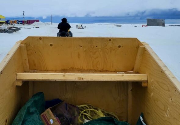 Towed along in a sturdy wooden qamutik, you feel the crisp, biting air hitting your face.