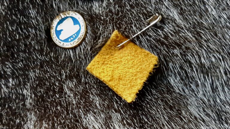 A small square of moose hide pinned close to the heart, symbolizing a personal commitment to stand against violence and support safer, more respectful communities.