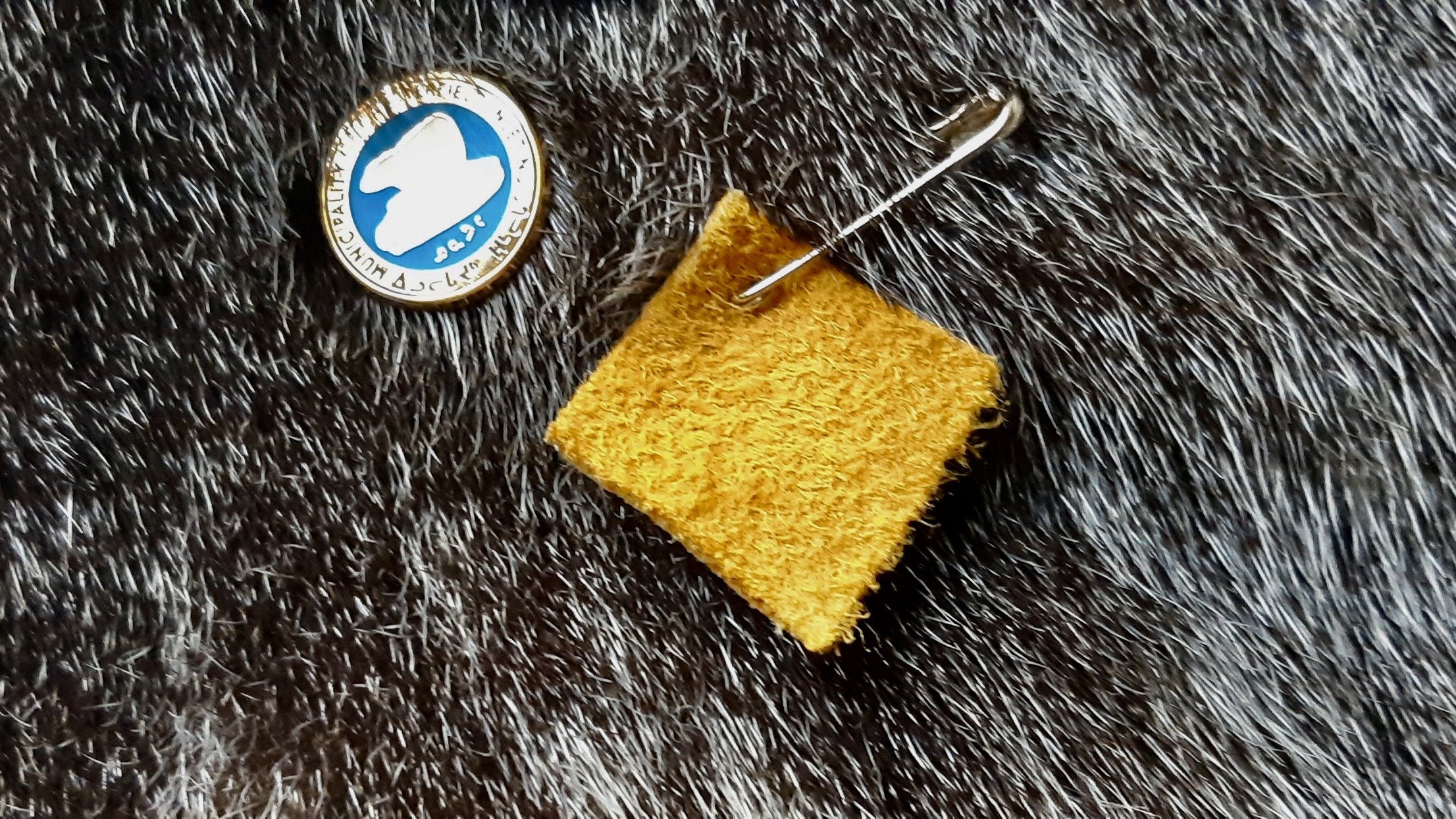 A small square of moose hide pinned close to the heart, symbolizing a personal commitment to stand against violence and support safer, more respectful communities.