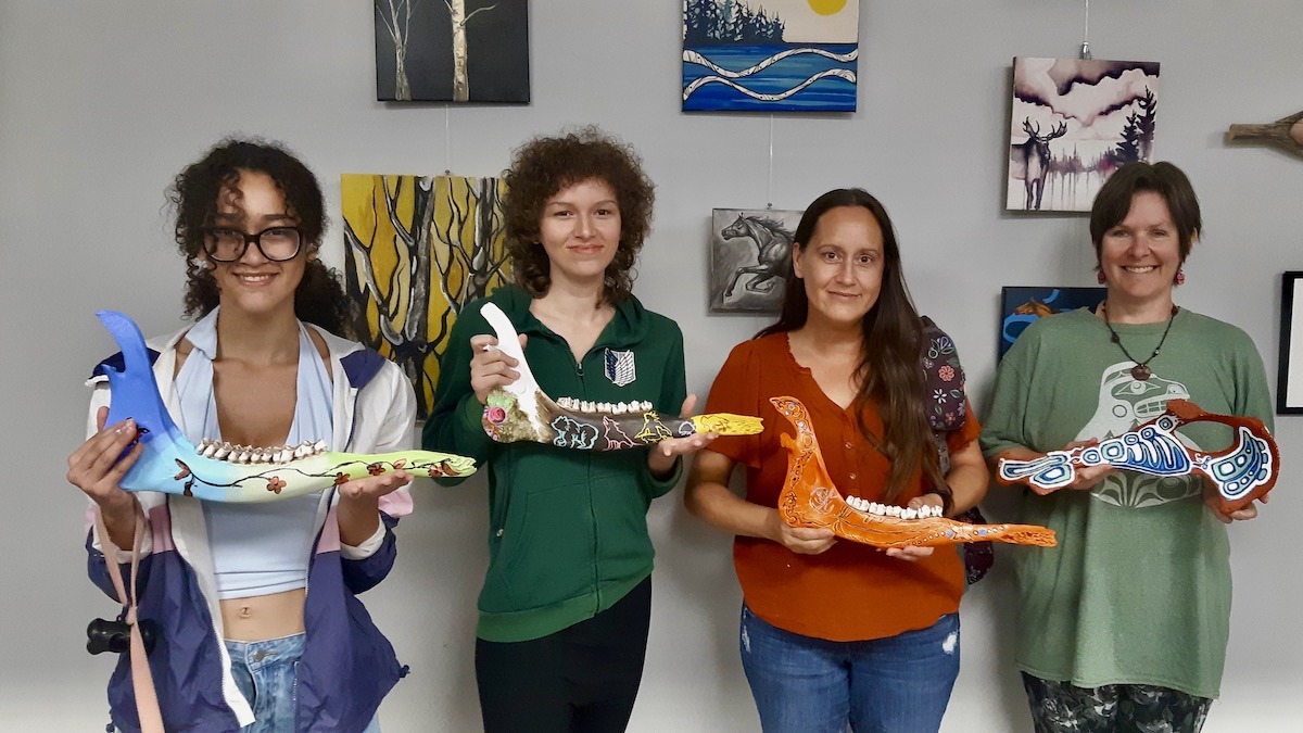 Artists with this year's summer arts incubator program show their newly painted creations.