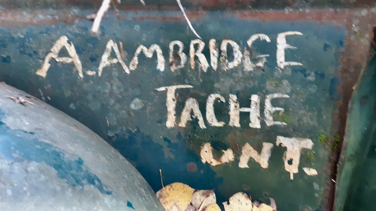 Hand-painted lettering reading "A. AMBRIDGE TACHE ONT." on the side bed panel gives a direct glimpse into this truck's working past in Northwestern Ontario.
